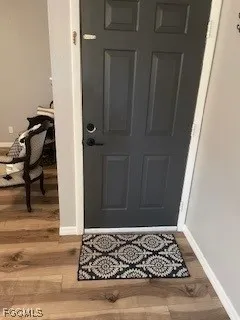 a view of an entryway with wooden floor