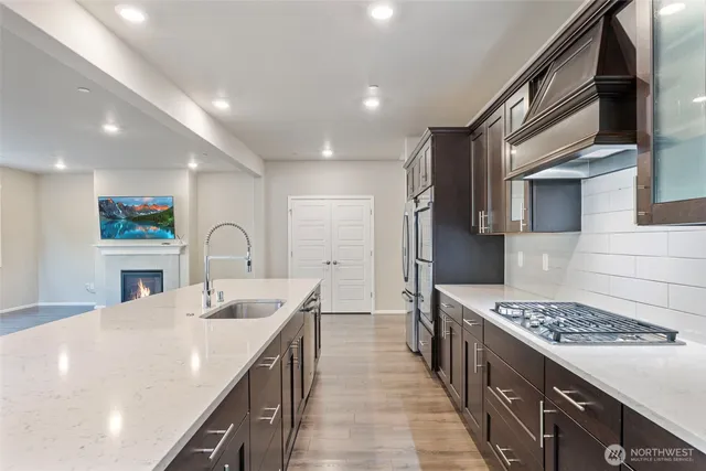 a kitchen with a sink stove and cabinets