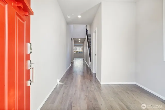 a view of a hallway with wooden floor