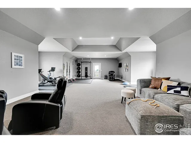 a living room with stainless steel appliances kitchen island granite countertop lots of furniture