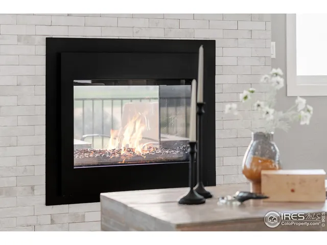 a living room with furniture white walls and kitchen view