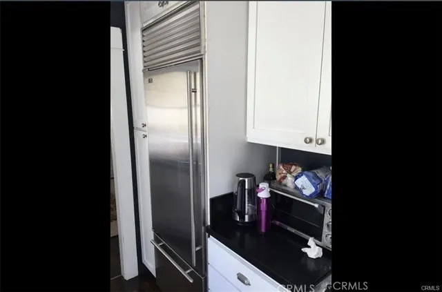 a kitchen with a refrigerator and a stove top oven