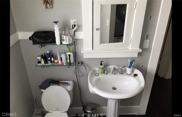 a bathroom with a toilet a sink and a mirror