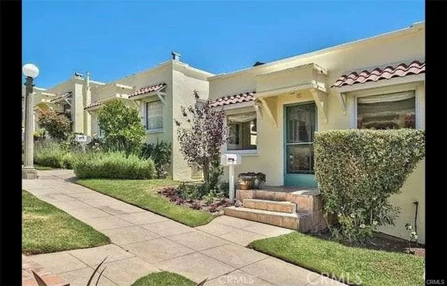 a front view of a house with garden