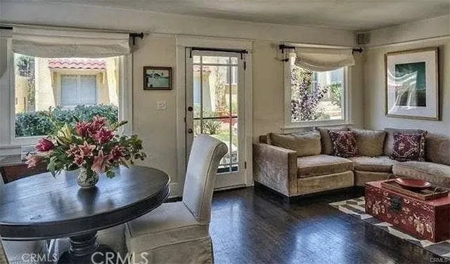 a living room with furniture and a potted plant