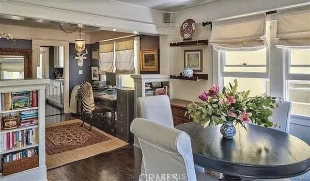a view of a dining room with furniture and a potted plant
