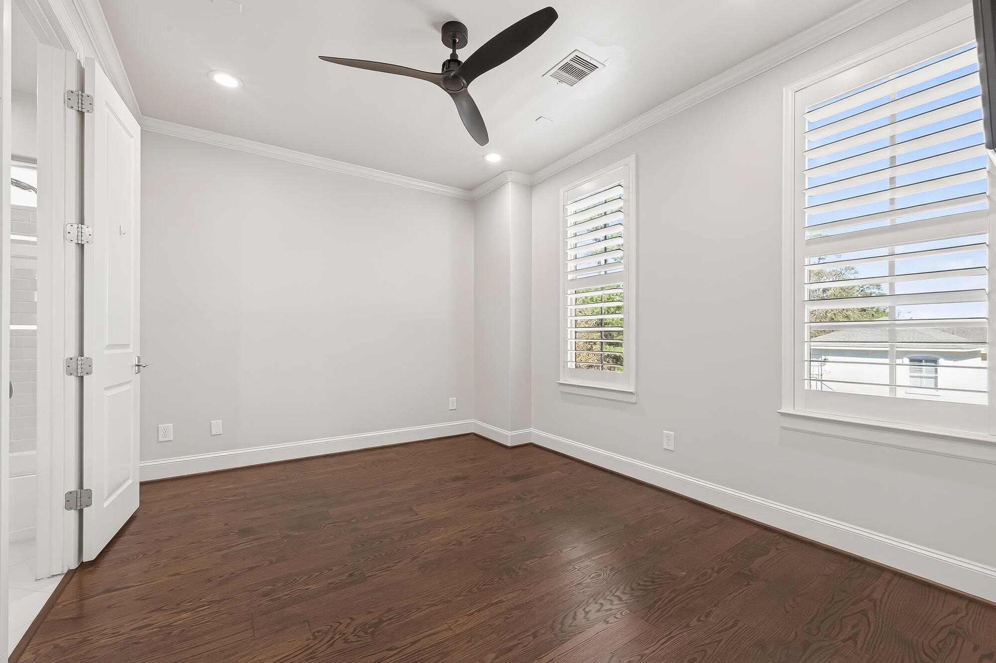 122 Gateway Park Place Spring, TX 77380 - Photo 33 of 44 Freshly painted bedroom with upgraded wood flooring, crown molding, and plantation shutters for bright comfort.