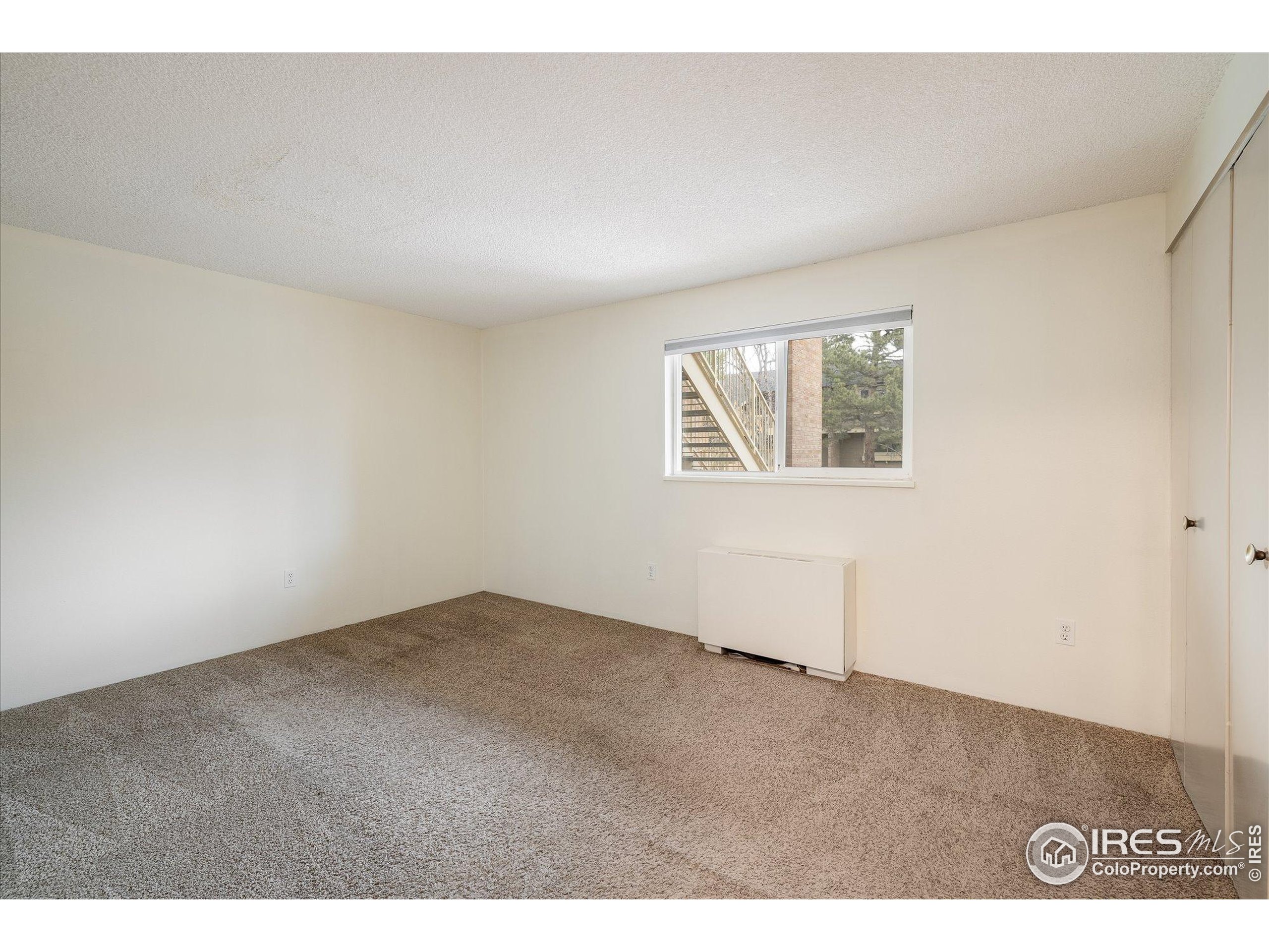 3000 Colorado Avenue, Unit 122 Boulder, CO 80303 - Photo 13 of 31 an empty room with windows