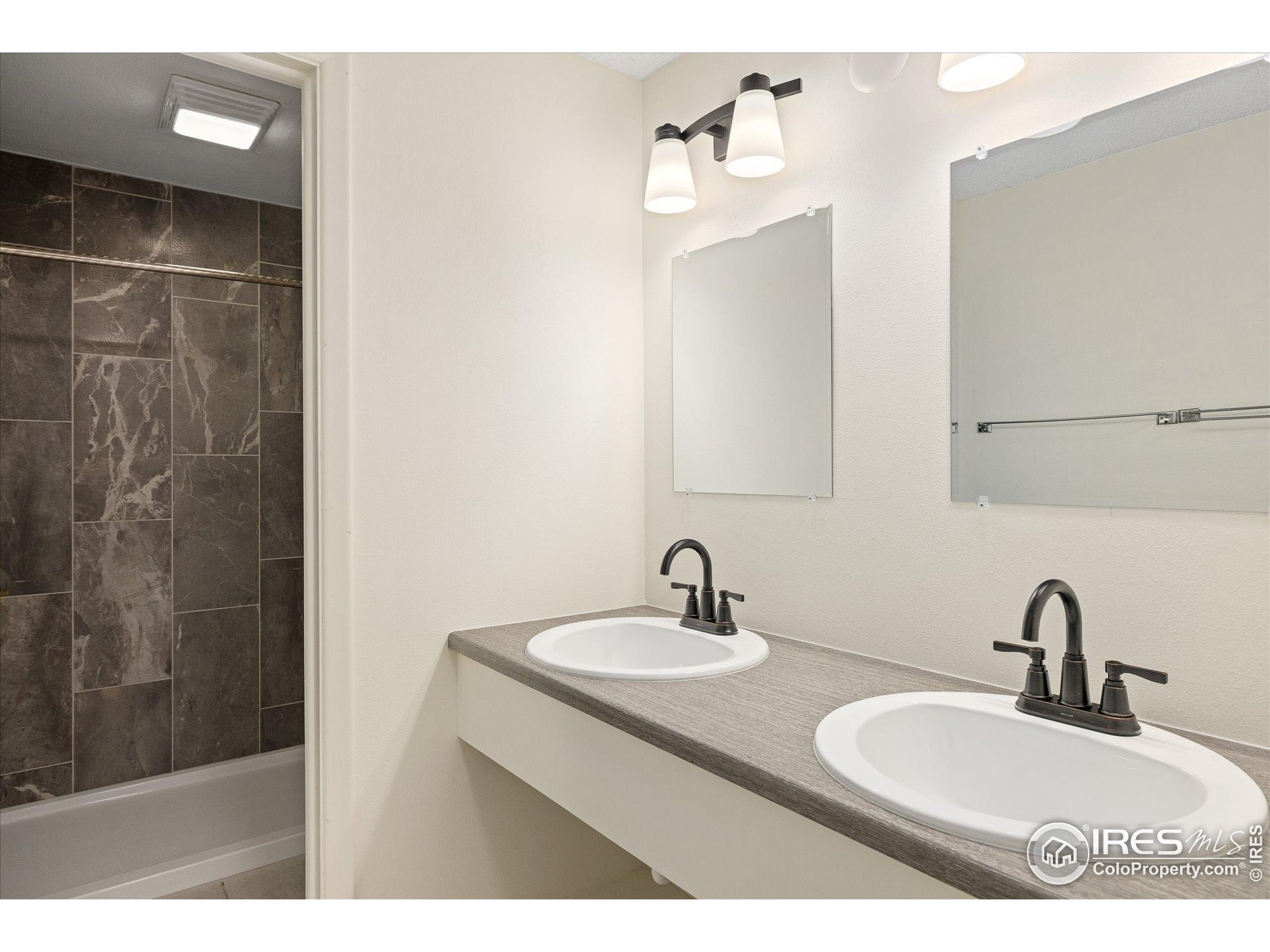 3000 Colorado Avenue, Unit 122 Boulder, CO 80303 - Photo 17 of 31 a bathroom with a sink double vanity and a mirror