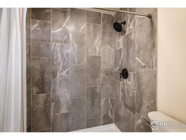 a bathroom with a shower and a toilet