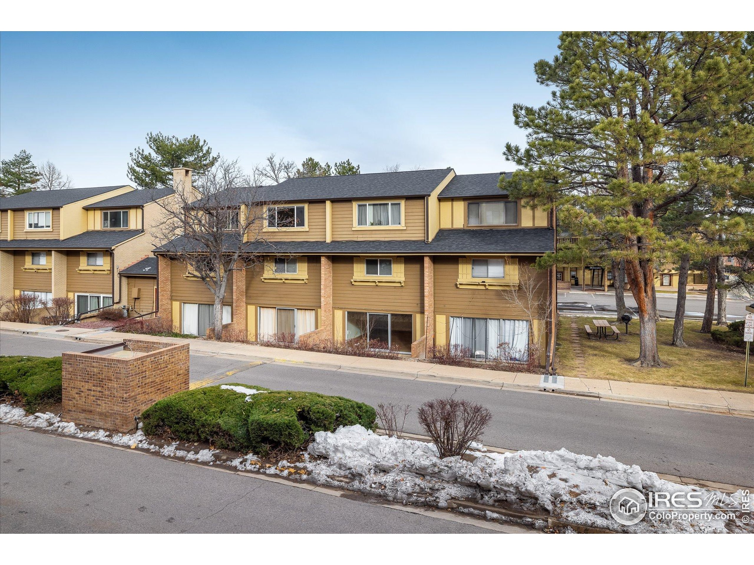 3000 Colorado Avenue, Unit 122 Boulder, CO 80303 - Photo 22 of 31 a front view of a residential apartment building with a yard
