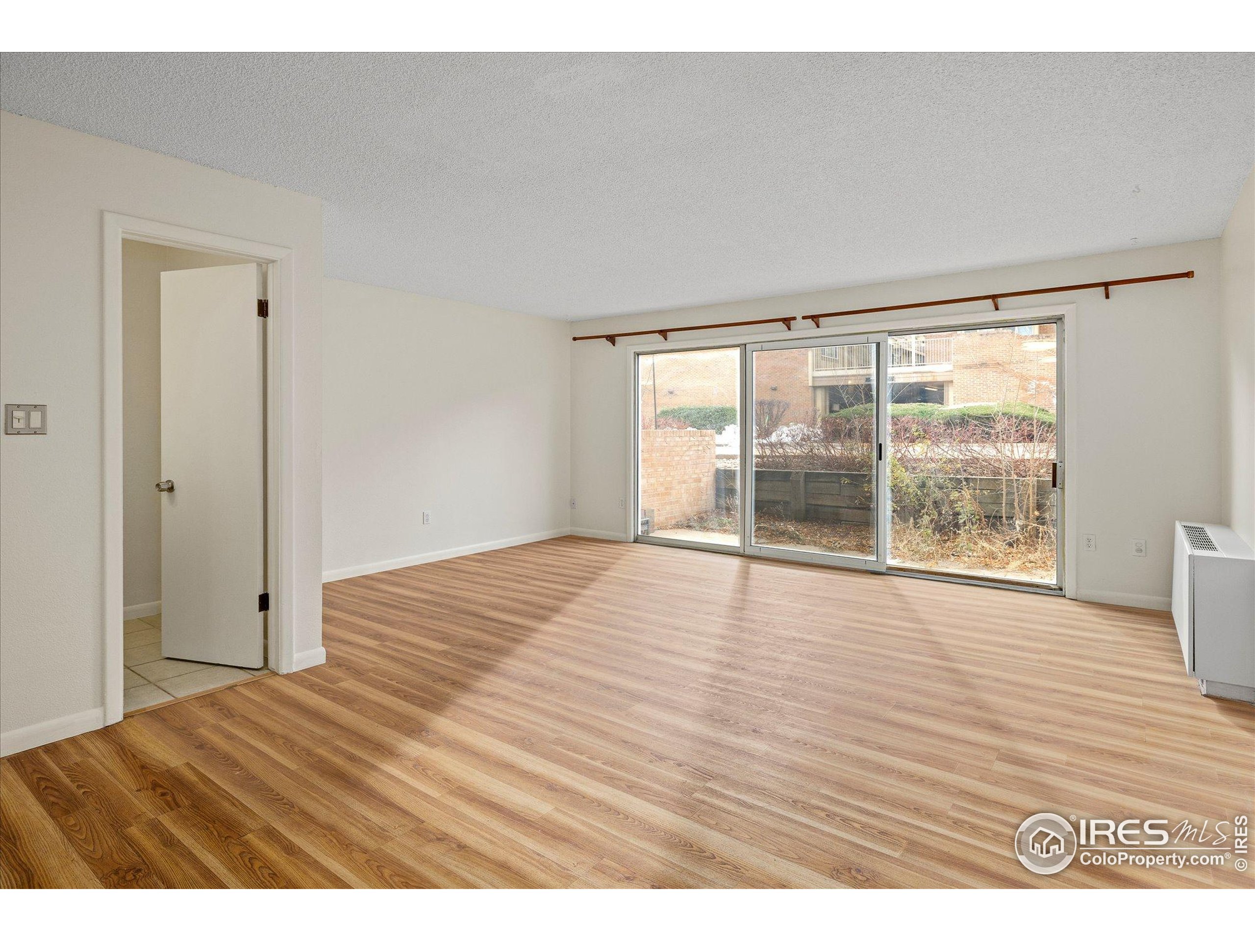 3000 Colorado Avenue, Unit 122 Boulder, CO 80303 - Photo 8 of 31 a view of empty room with wooden floor and fan