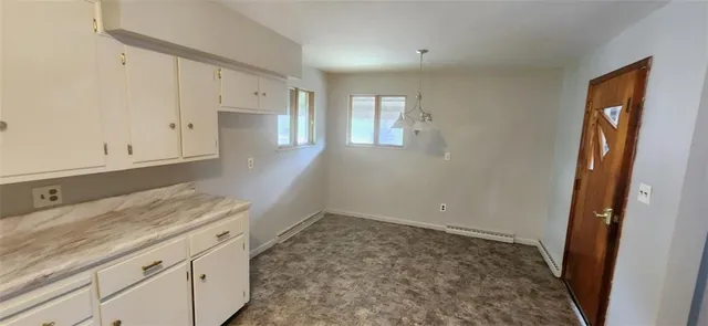 a kitchen with granite countertop white cabinets and sink