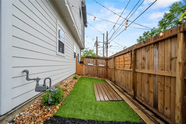 a view of a backyard with wooden fence