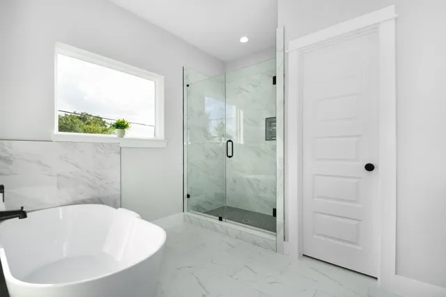a bathroom with a bathtub and shower