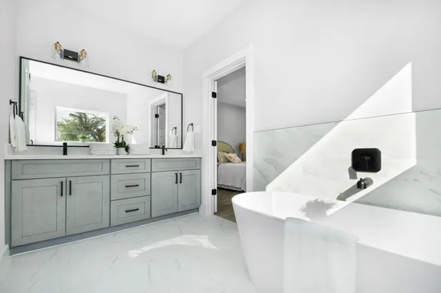 a spacious bathroom with a sink and a mirror