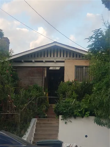 a view of house with outdoor space and garden