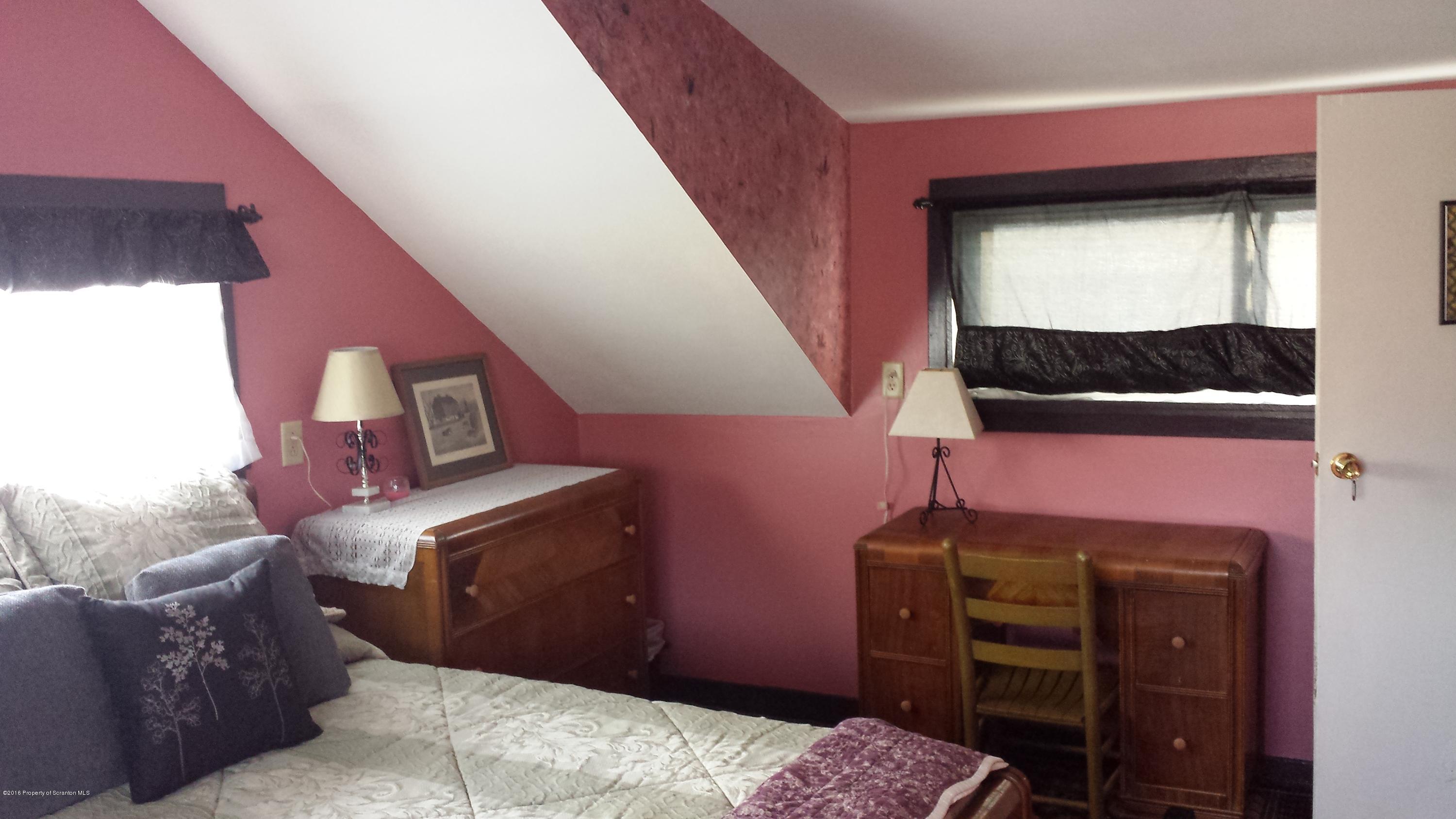 6591 Lindaville Road Kingsley, PA 18826 - Photo 23 of 28 a bedroom with a bed and a television
