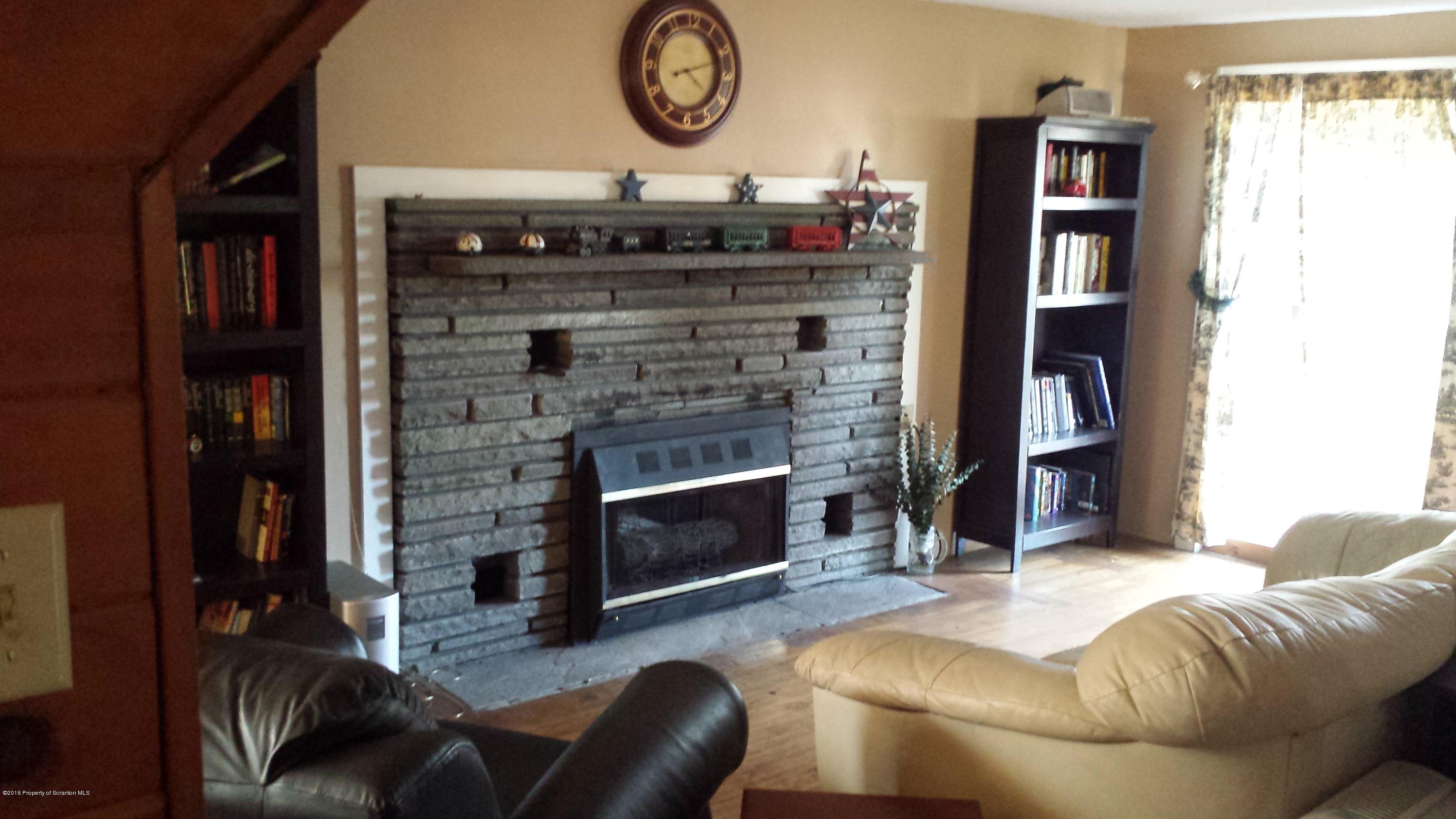 6591 Lindaville Road Kingsley, PA 18826 - Photo 6 of 28 a living room with furniture and a fireplace