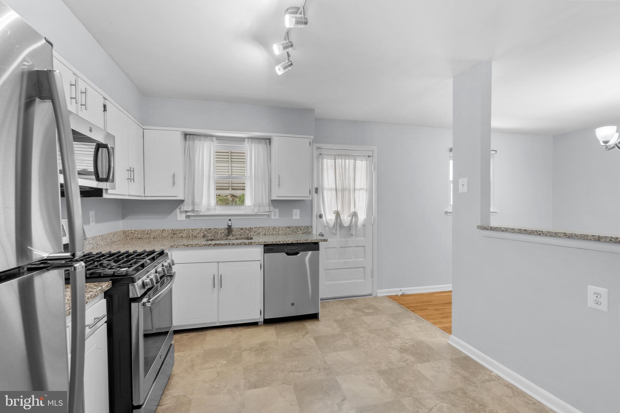 1201 Chillum Manor Road Hyattsville, MD 20783 - Photo 21 of 49 a kitchen with stainless steel appliances granite countertop a sink stove and refrigerator