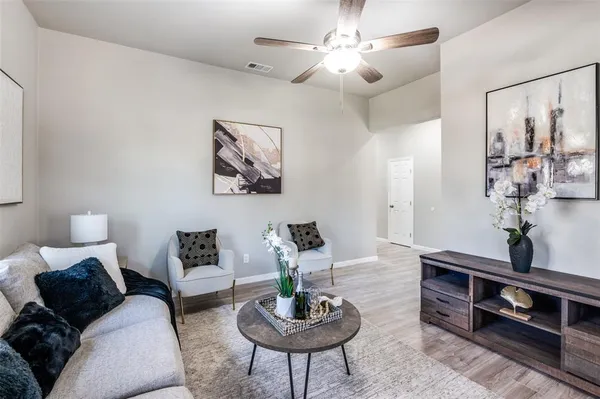 a living room with furniture and a mirror