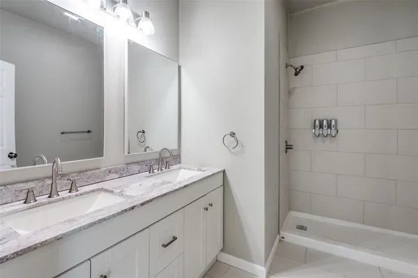 a bathroom with a granite countertop sink mirror and double