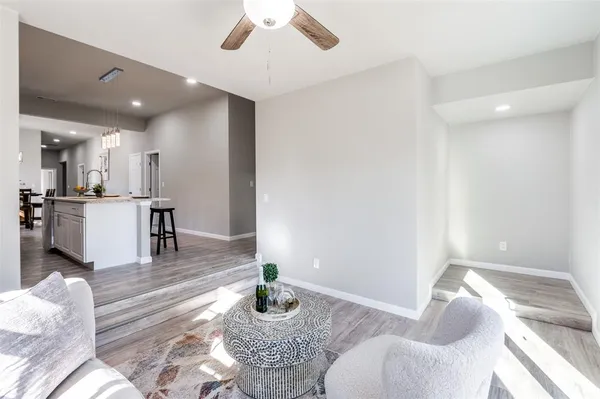 a living room with furniture and a kitchen