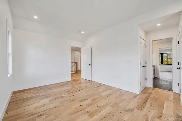 a bedroom with a large bed and windows