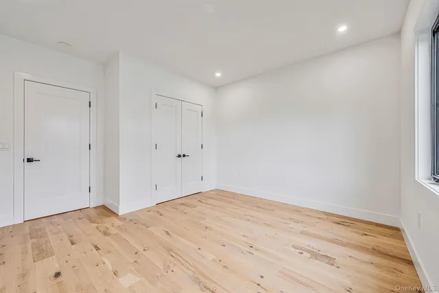 a bedroom with a large bed and a potted plant