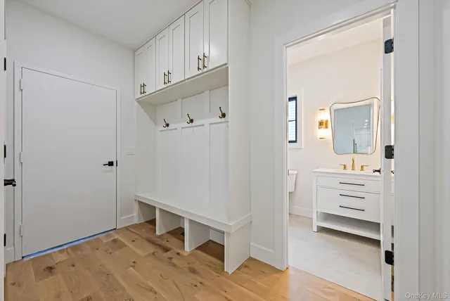 a bathroom with a toilet a sink a mirror and vanity