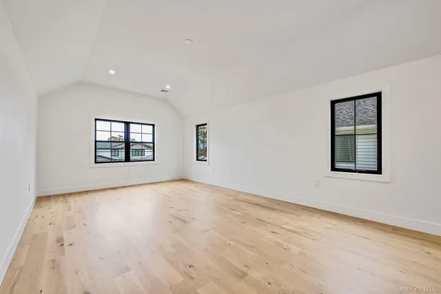 a bathroom with a toilet a sink a glass door a shower a mirror and vanity
