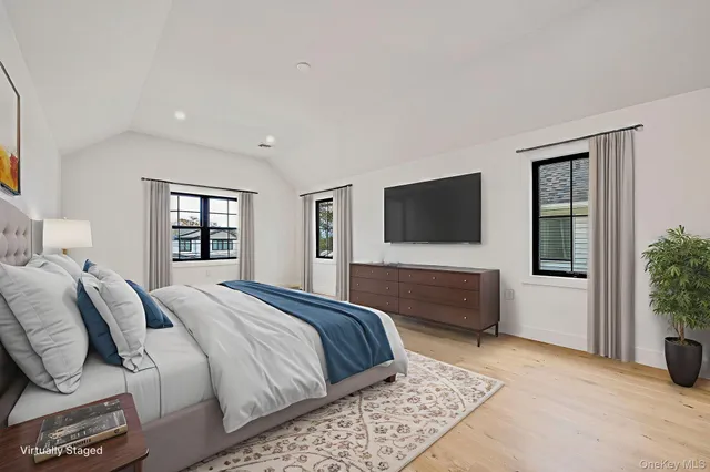 a spacious bedroom with a large bed and a couch