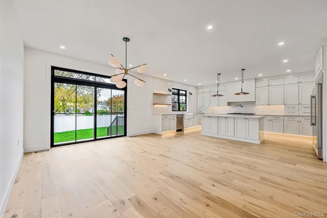 a view of a kitchen with a sink and a refrigerator