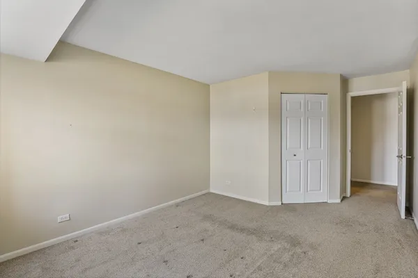 a view of an empty room and closet area