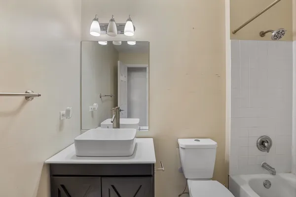 a bathroom with a sink toilet a mirror and vanity