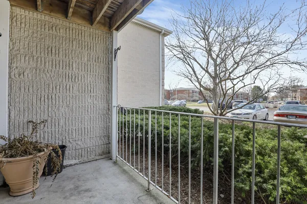 a view of a balcony with yard