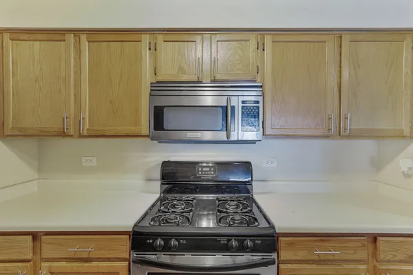a kitchen with granite countertop a stove and a cabinet