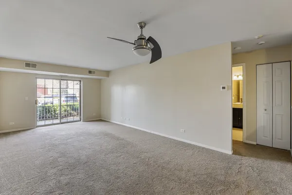 a view of an empty room with windows