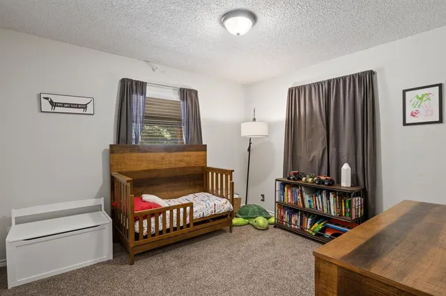 a bedroom with furniture and a baby crib