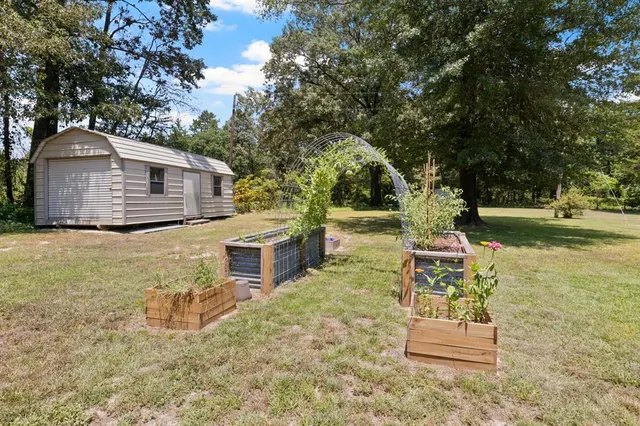 a view of a house with backyard and sitting area