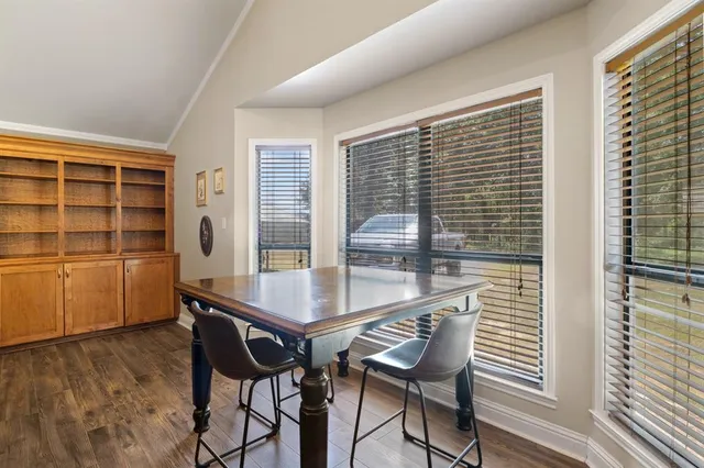 a view of a dining room with furniture and window