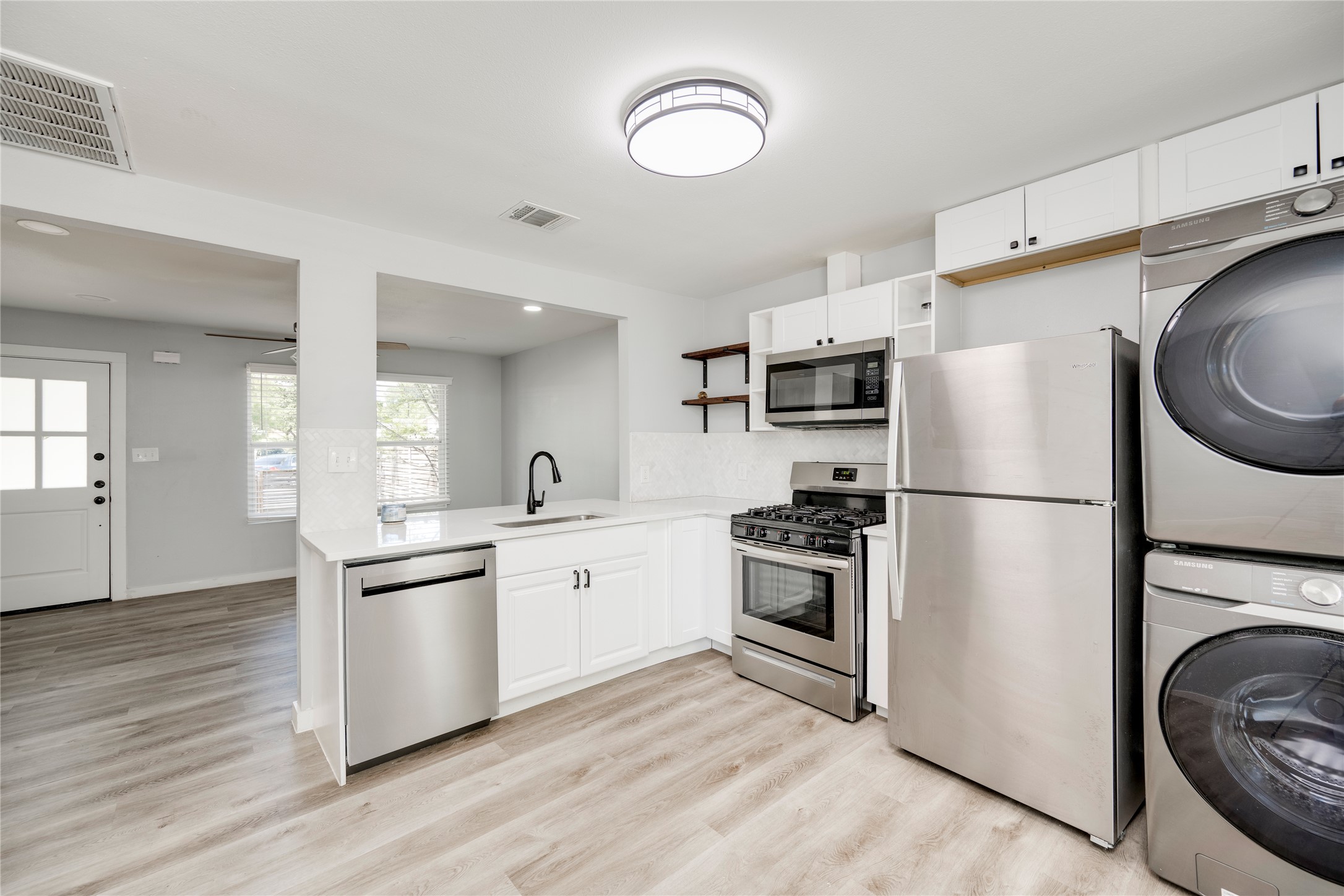 1400 Marcus Place, Unit B Austin, TX 78721 - Photo 24 of 39 A well-appointed kitchen features stainless steel appliances and abundant natural light.