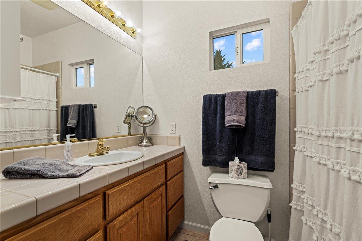 6980 Timeview Way Prunedale, CA 93907 - Photo 17 of 47 a bathroom with a granite countertop toilet sink and mirror