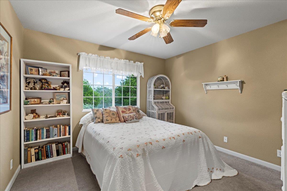 6980 Timeview Way Prunedale, CA 93907 - Photo 22 of 47 a bedroom with a large bed and a chandelier