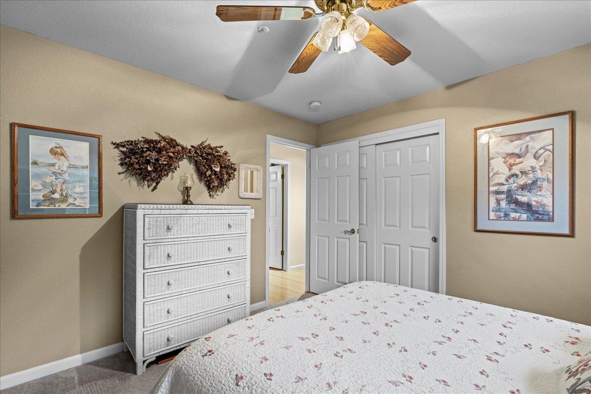 6980 Timeview Way Prunedale, CA 93907 - Photo 23 of 47 a bedroom with a bed and a chandelier