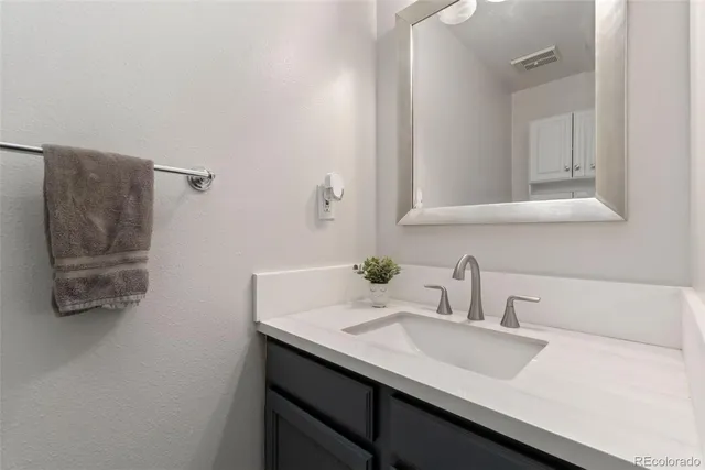 a bathroom with a sink and mirror