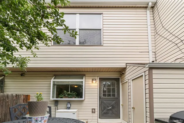 a view of a house with a window and sitting area