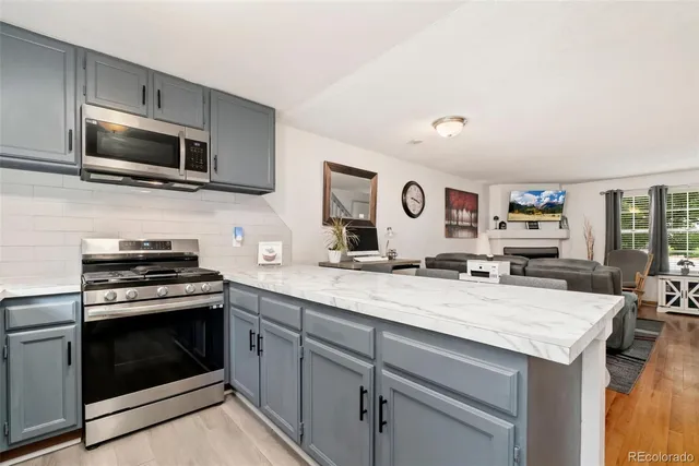 a kitchen with a sink stove and microwave