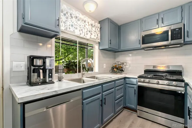 a kitchen with a sink stove and microwave