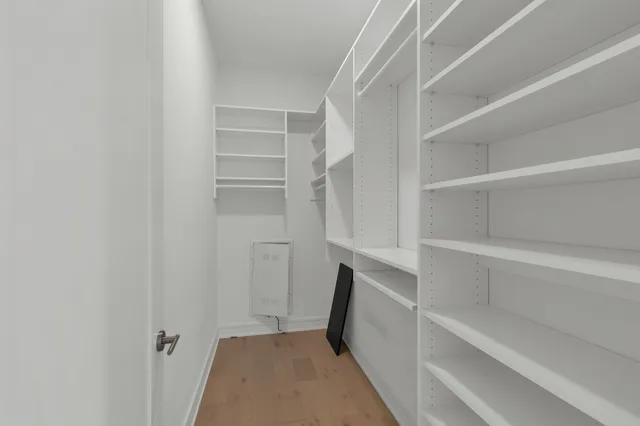 a view of walk in closet with empty racks